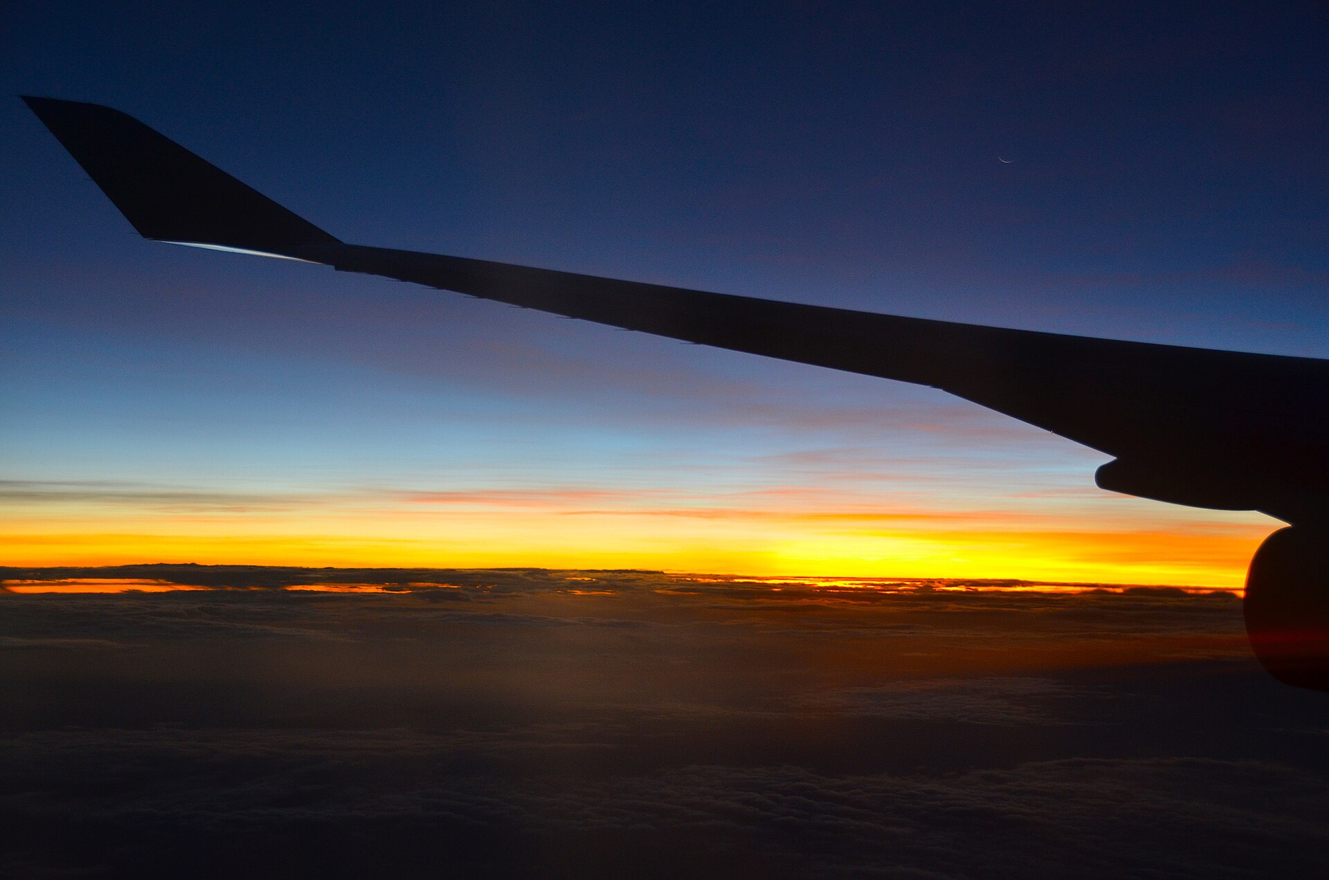 An aircraft wing at sunset